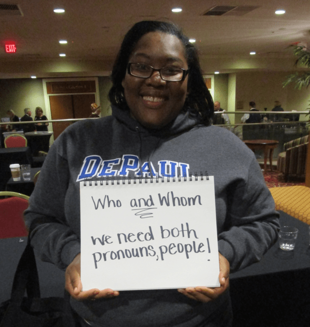 Copy Editor, Dilane Anner, with her grammar pet peeve. The sign reads, "who and whom we need both pronouns people."